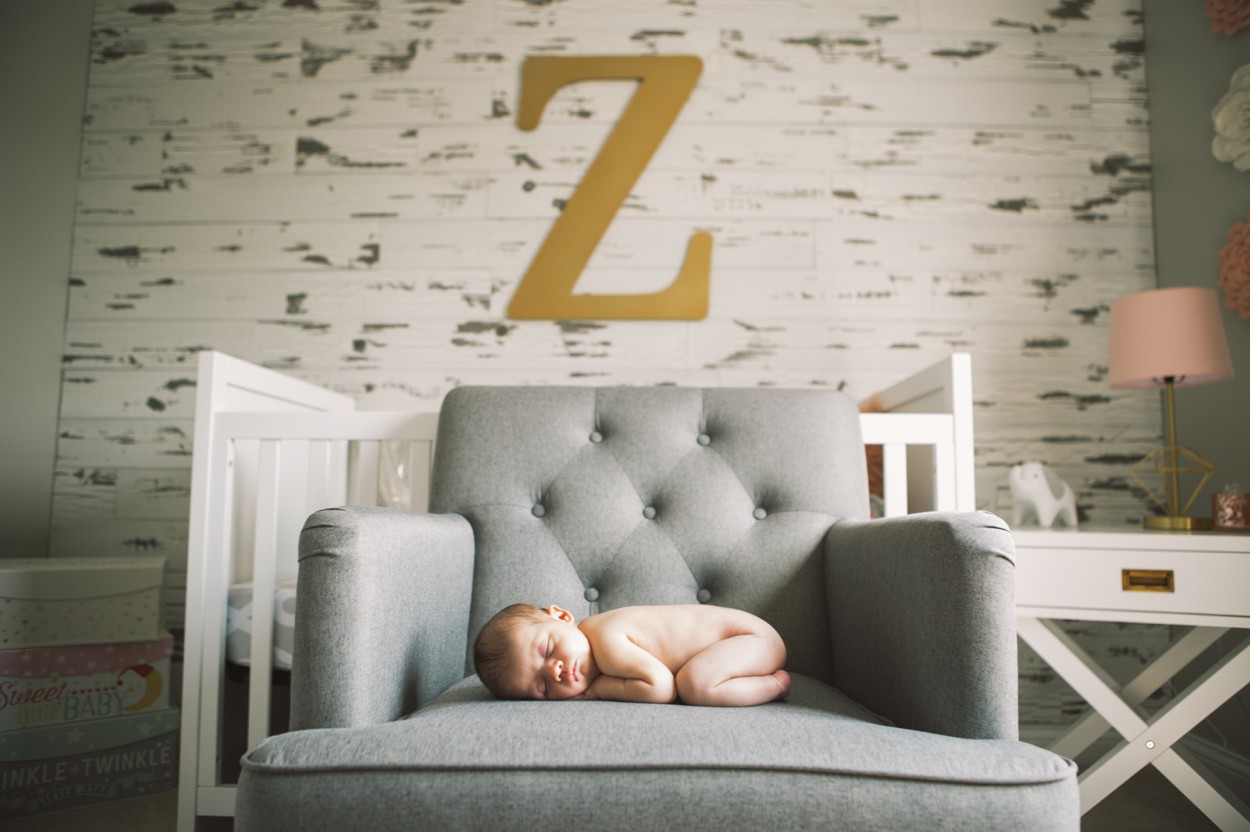 baby on chair with large letter z over it on dogwood wall in Noblesville Newborn Photos