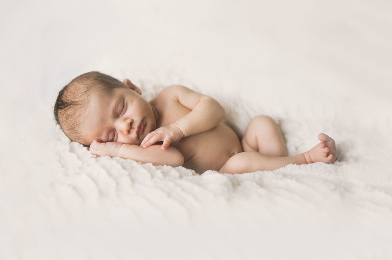 naked newborn on white blanket for baby photos