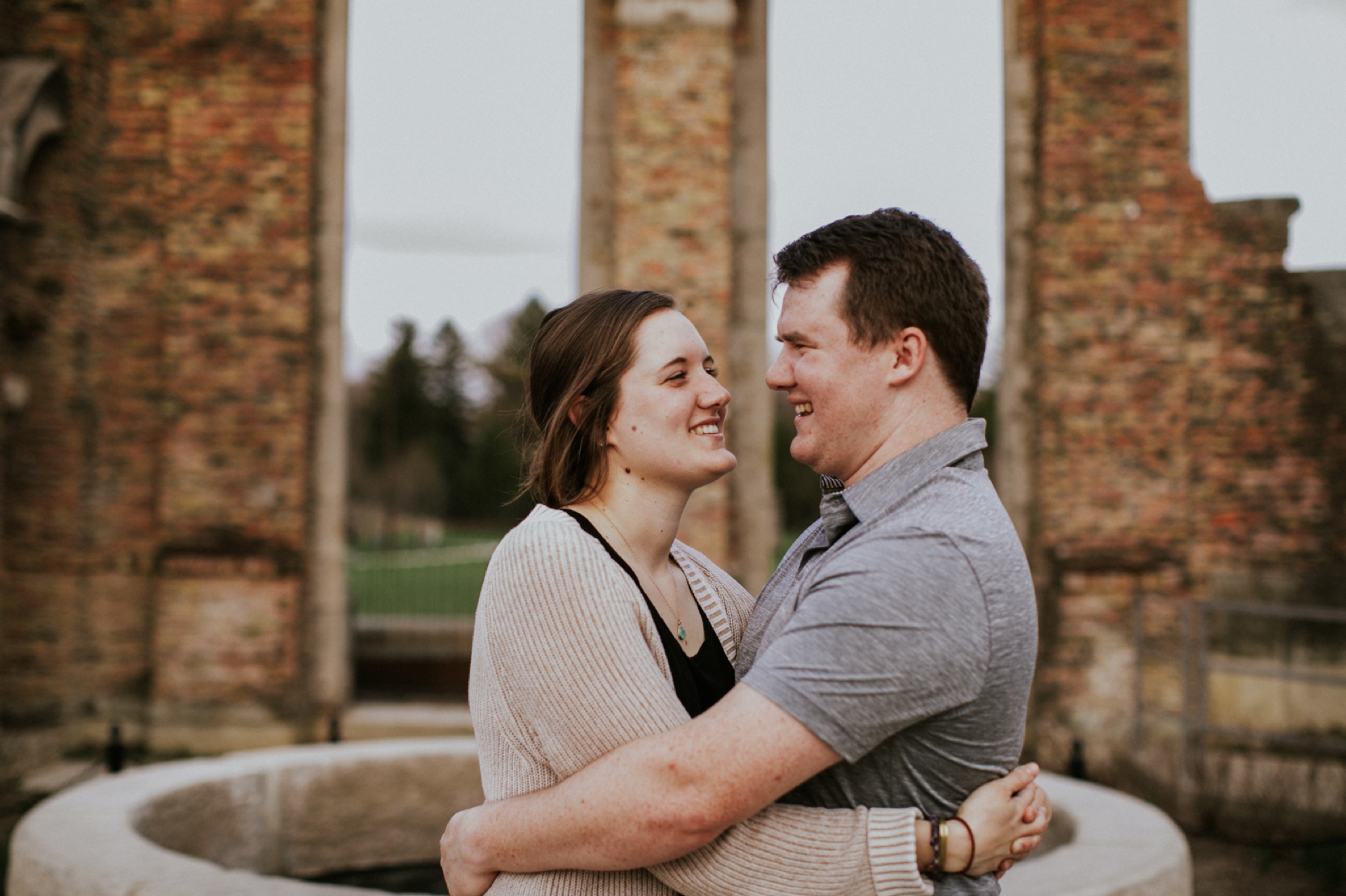 engagement session couple hugging each other in front of ruins at holliday park