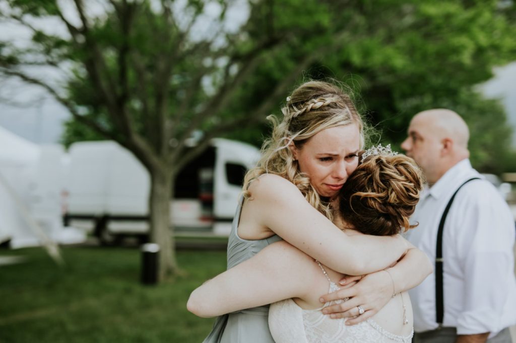 blonde girl hugs bride and cries at norris estate wedding