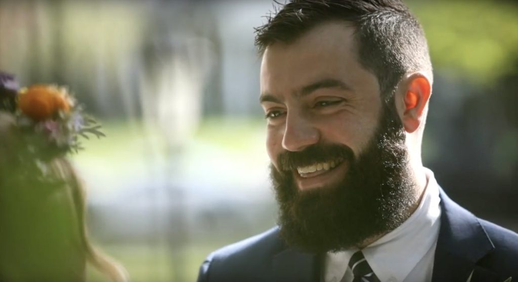 man laughs while looking at woman during their benton house wedding film