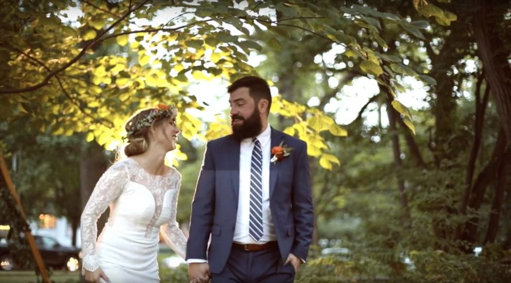 bride and groom walk and laugh at sunset during their benton house wedding film