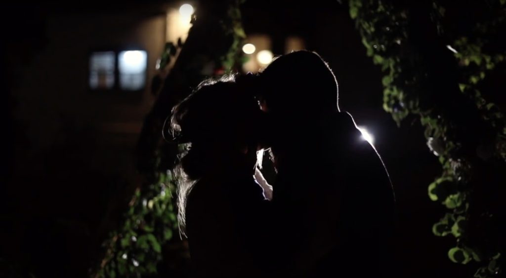 bride and groom kiss while backlit during their benton house wedding film