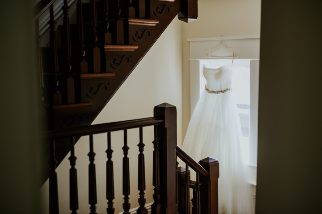 wedding dress hanging in a window in a stairwell in a house on Lockerbie Street