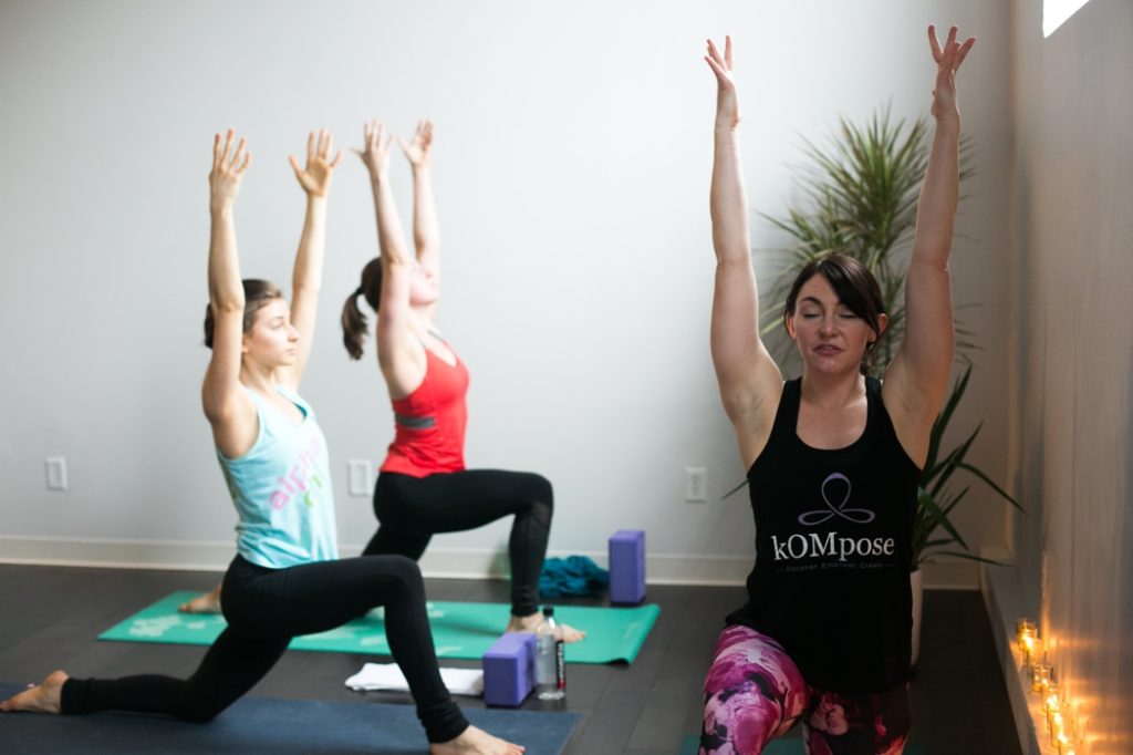 women lunging with arms in air during an Indianapolis Yoga Photography shoot