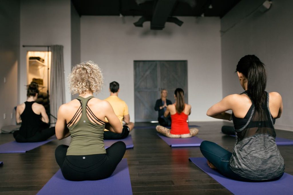 women meditate in yoga studio