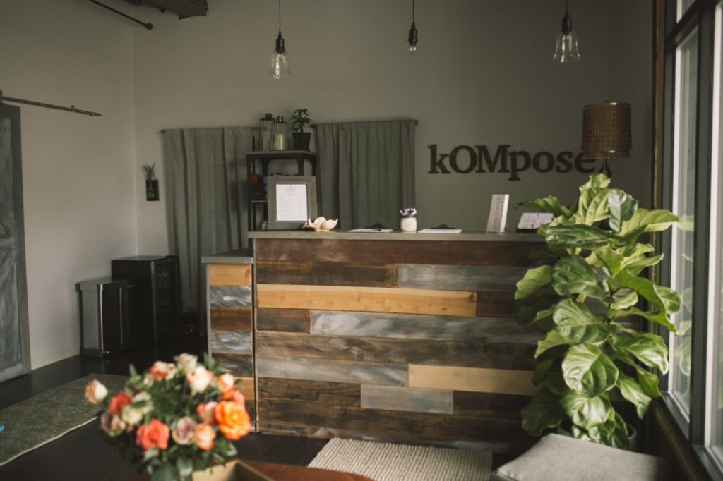 front room of kompose yoga studio with reclaimed wood desk