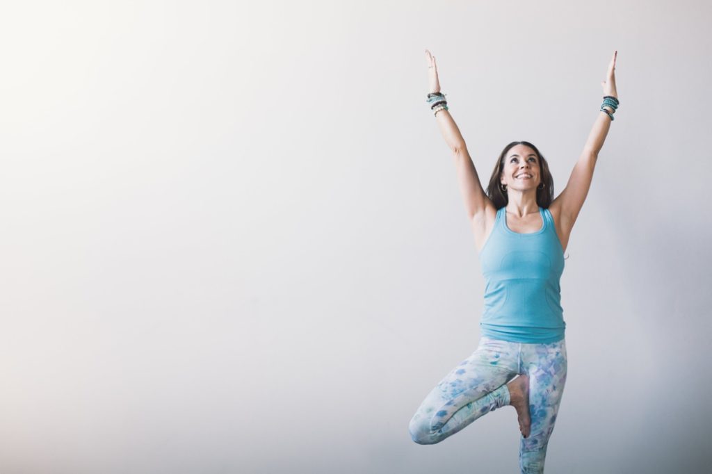 woman poses on one leg with arms raised during an Indianapolis Yoga Photography shoot