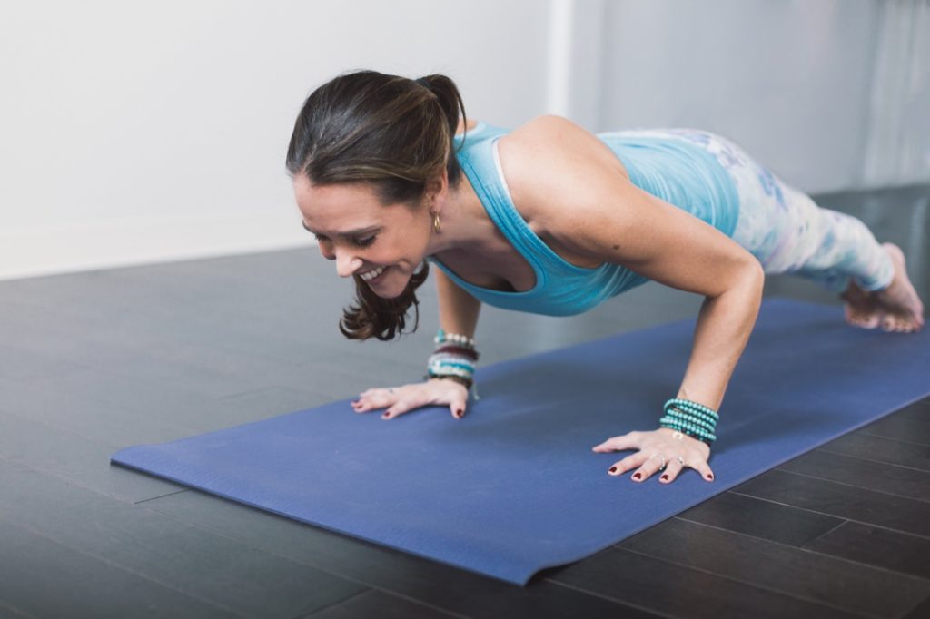 woman does pushups on a yoga mat during an Indianapolis Yoga Photography shoot