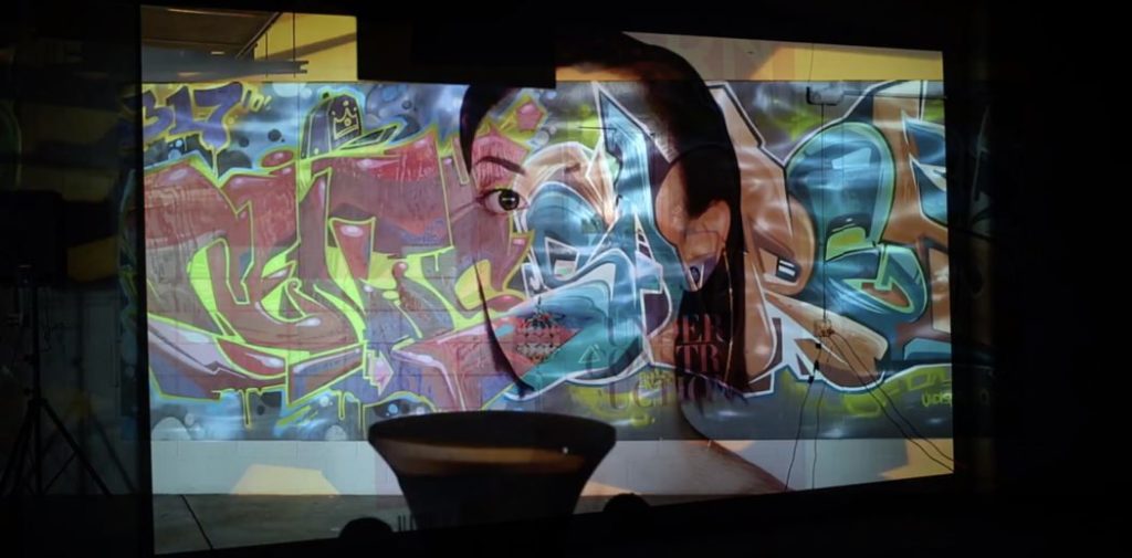 cover photo from issue 12 of pattern magazine projected on a wall during launch party with overlay of other wall art