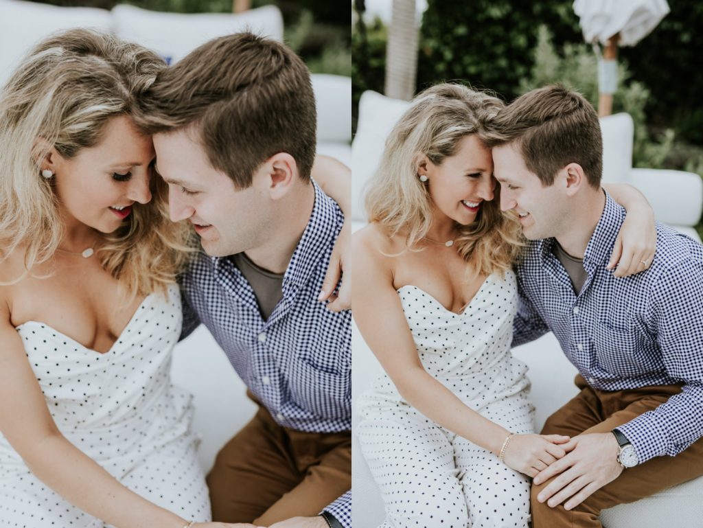 man and woman cuddle on white chairs during laguna beach engagement shoot at hotel joaquin
