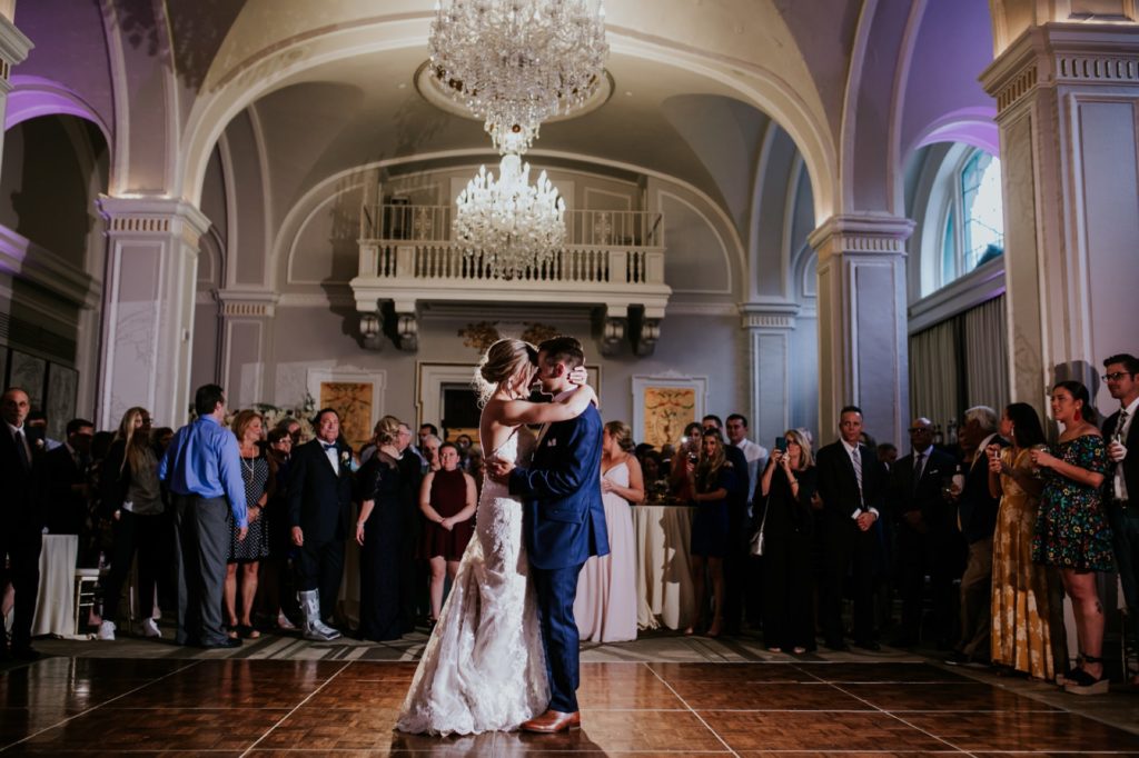 chandeliers hang over the bride and groom during their first dance at their Omni Severin Wedding