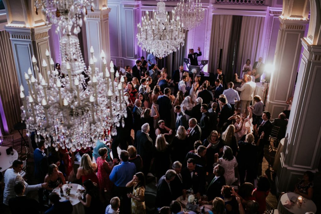 chandeliers hang over the dance floor at an Omni Severin Wedding