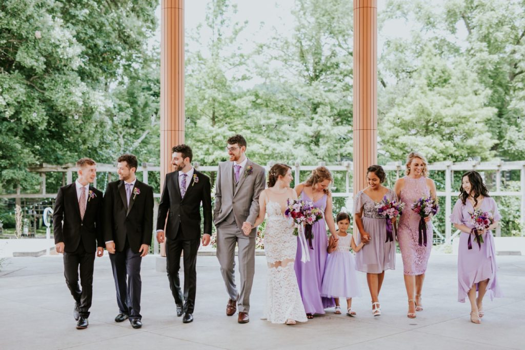 bride and groom walk with bridal party in suits and pink dresses at Indianapolis Art Center