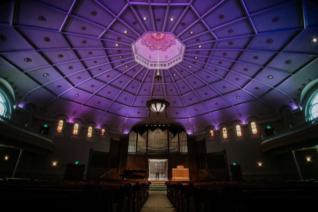 wide shot of indiana landmarks wedding sanctuary with purple uplighting