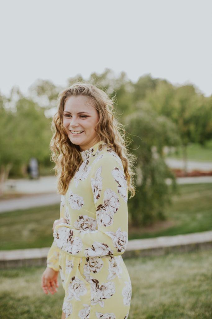 blonde girl in yellow floral dress in park at sunset in this Westfield Senior Portrait