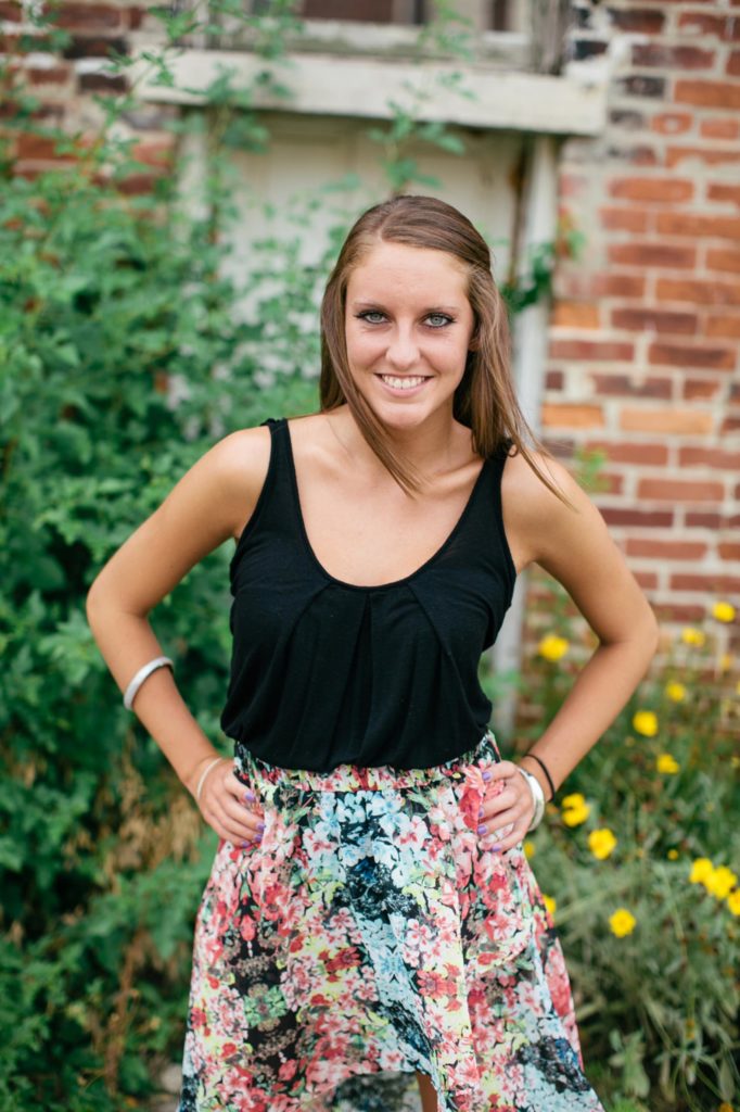 girl in floral skirt with hands on hips in muncie senior photography