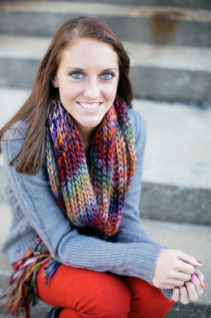 girl in scarf and grey sweater sits on steps in muncie indiana