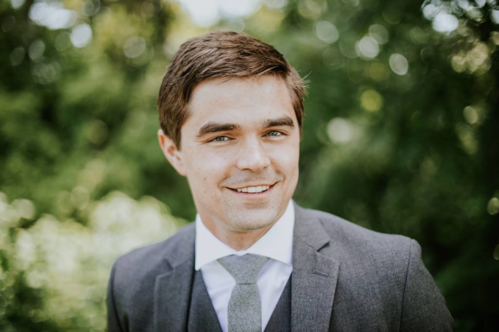 head shot of groom smiling in forest for muncie wedding photography