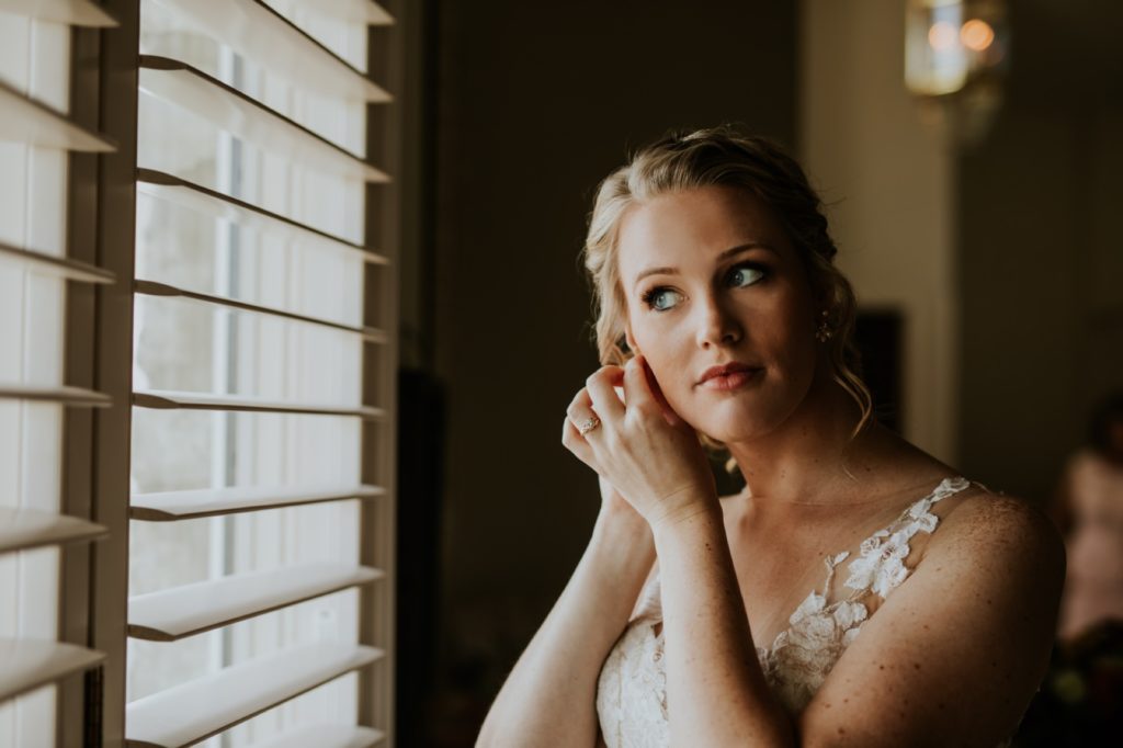 bride puts earrings in for muncie wedding photography