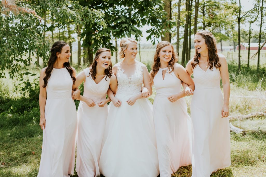 bride walking with bridesmaids outside for muncie wedding photography