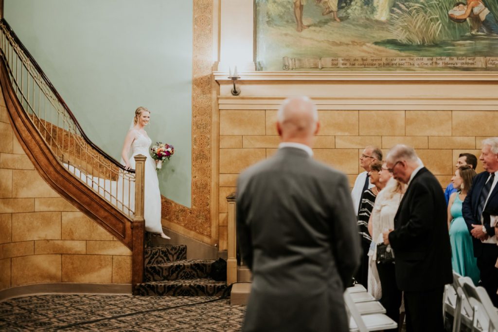 bride approaches father to walk down aisle