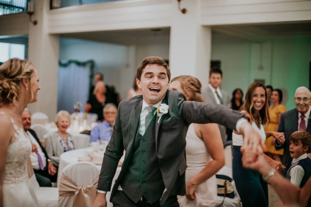 groom laughs and dances at cornerstone center for the arts