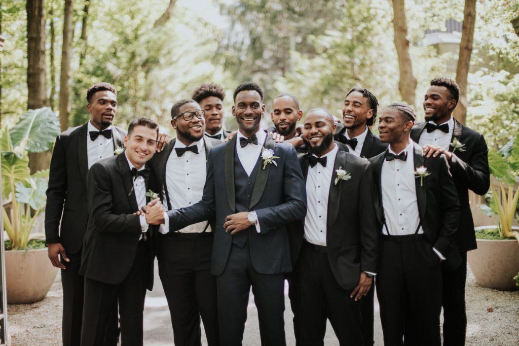 groom and groomsmen smile during newfields wedding photography