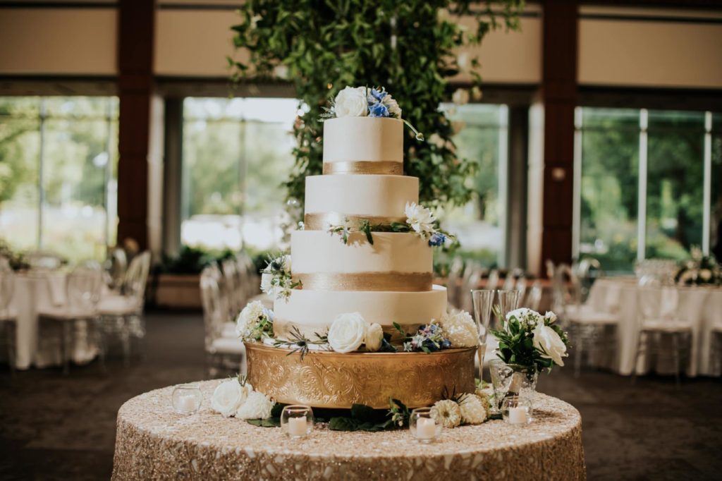 four tiered wedding cake in deer zink pavilion at newfields wedding