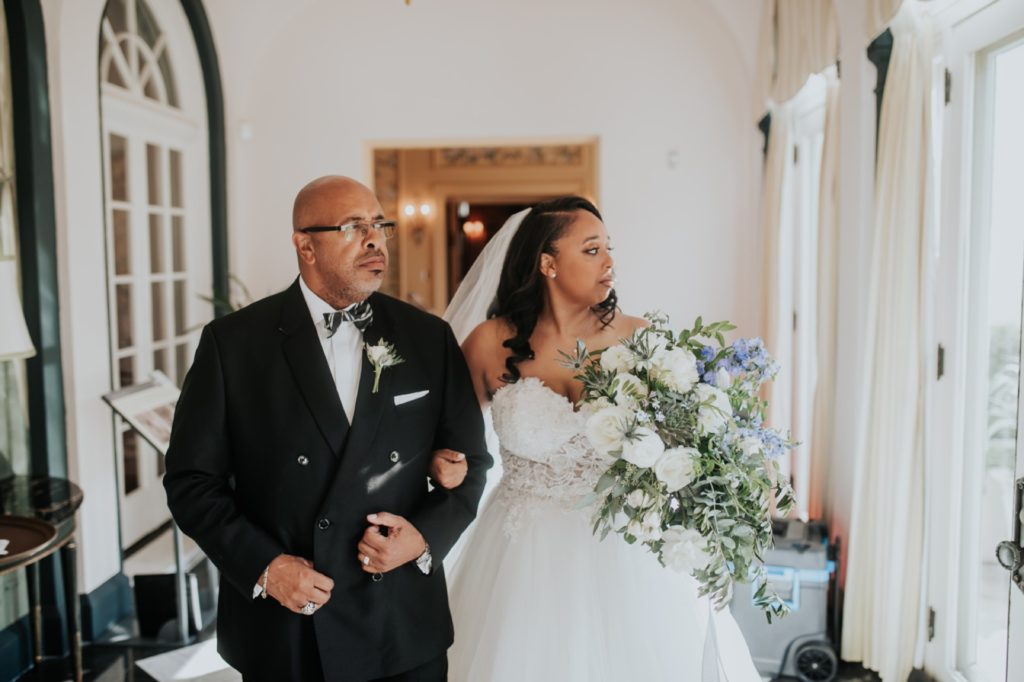 father of bride and bride walk out of lilly house to newfields wedding ceremony