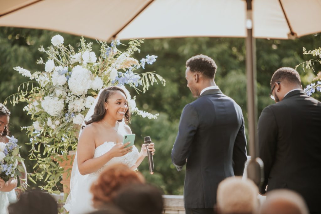 bride smiles while saying vows during newfields wedding ceremony