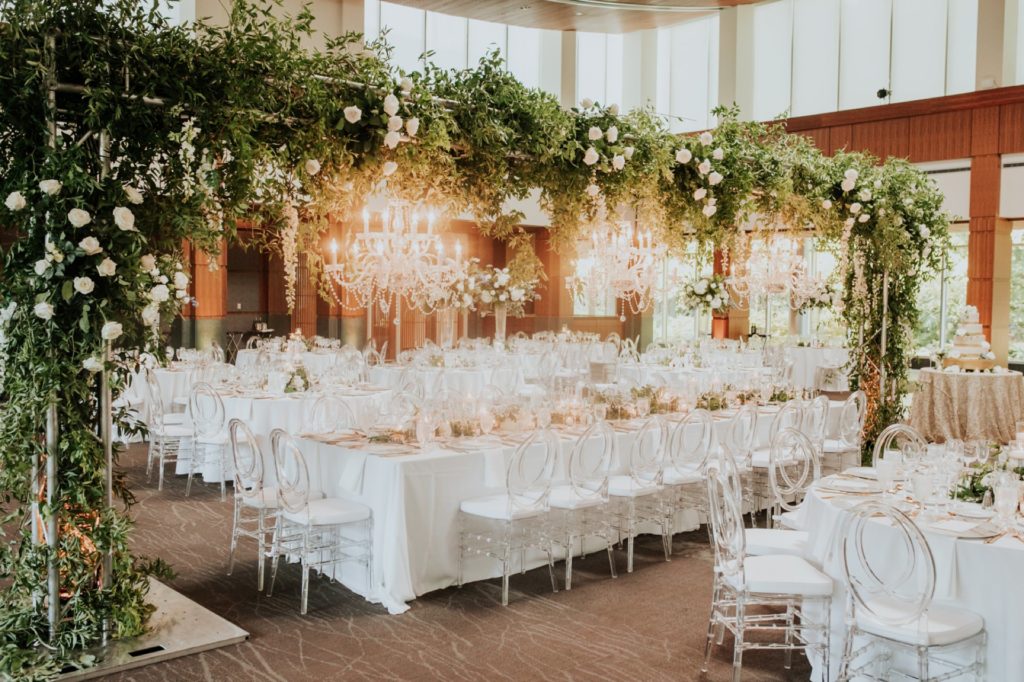 floral arch over head table with chandeliers and candles in Deer Zink Pavilion at Newfields Wedding