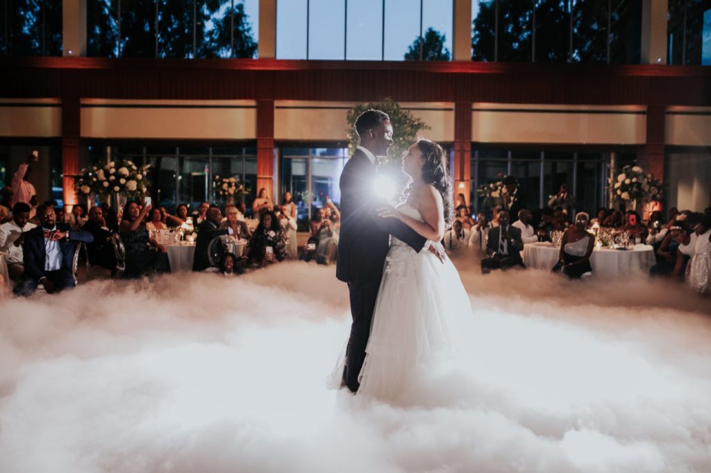 bride and groom dance in dry ice cloud during newfields wedding