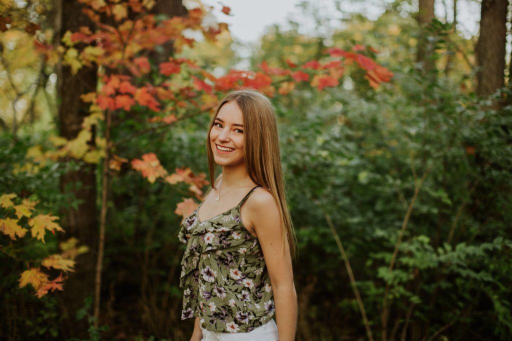 girl in floral tank top in autumn in Noblesville Senior Photos
