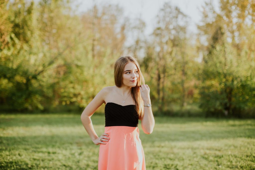 girl in pink dress in open field for Noblesville Senior Portraits
