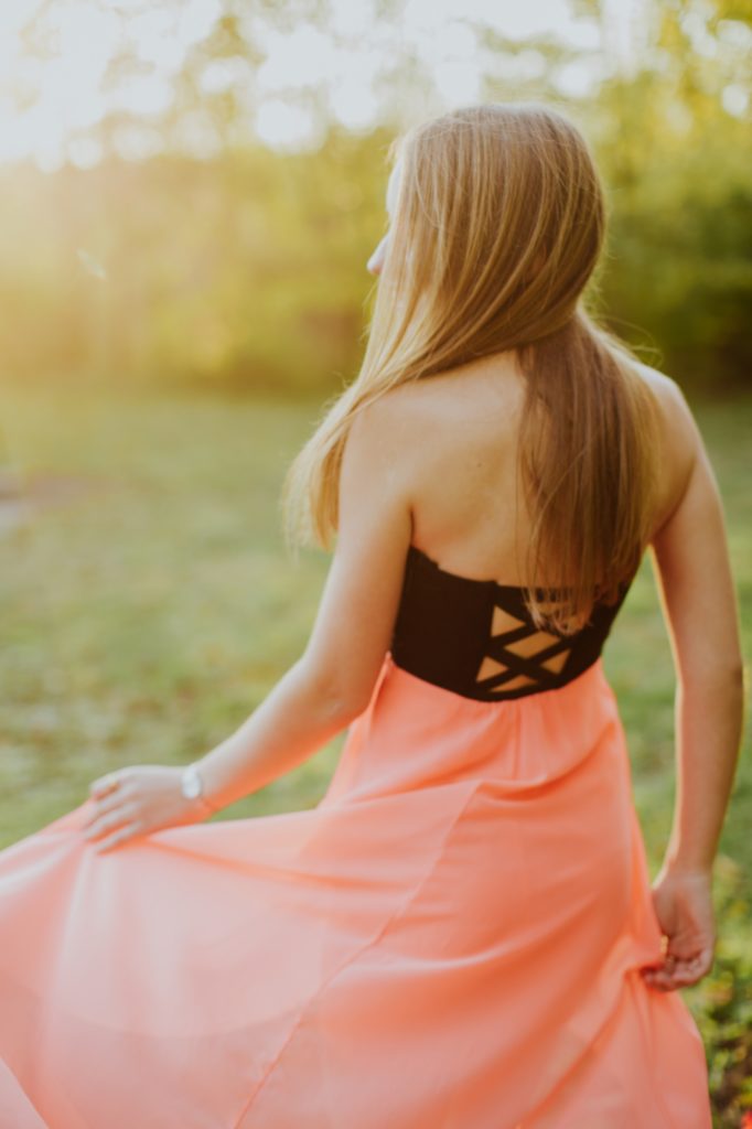girl in pink dress walks into sunset for Carmel Photos