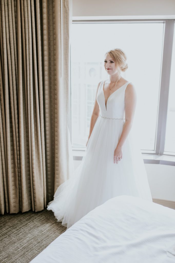 bride in white dress framed by window at the Westin
