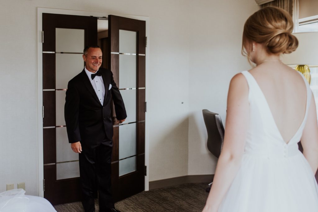 father of the bride sees his daughter for the first time on her wedding day at the westin hotel before her Tinker House Wedding