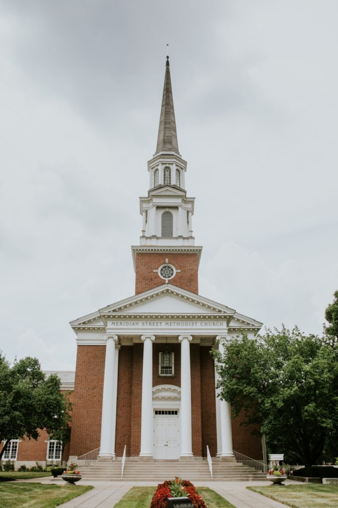 steeple of the meridian street united methodist church on a cloudy day