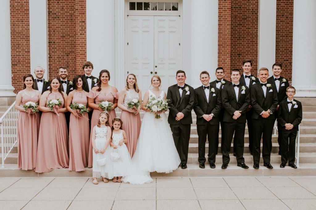 full bridal party on the steps of the meridian street united methodist church