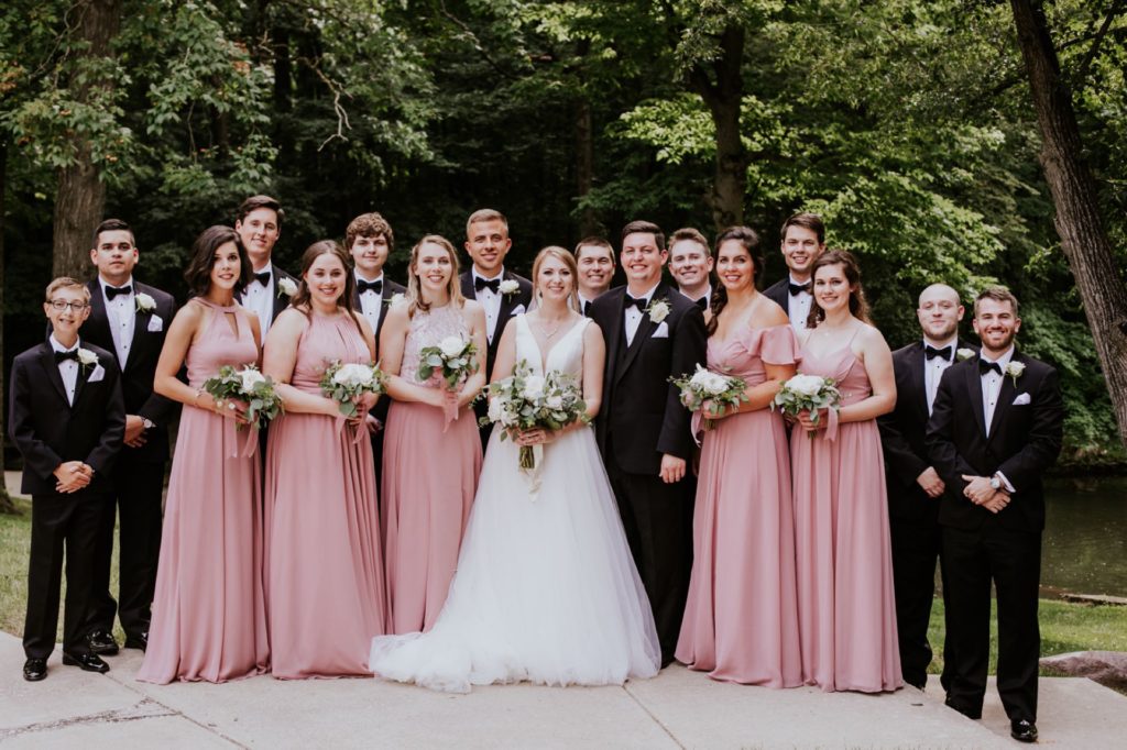 full bridal party lined up at holcomb gardens at butler university for a Tinker House Wedding