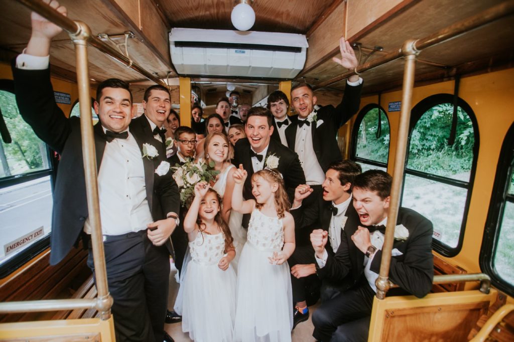 bride and groom and bridal party on an Indy Trolley partying before their Tinker House Wedding