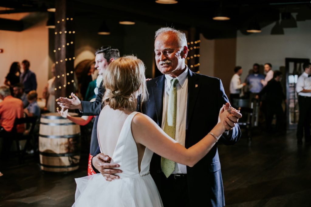 an old man dances with a bride during a Tinker House Wedding