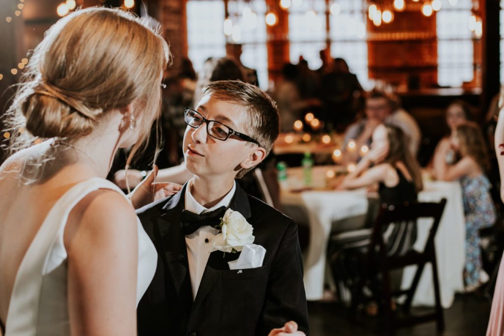 the bride dances with her younger brother during a Tinker House Wedding