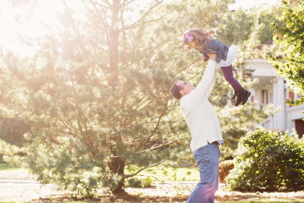 dad throws daughter into air and catches her Muncie Family Photography