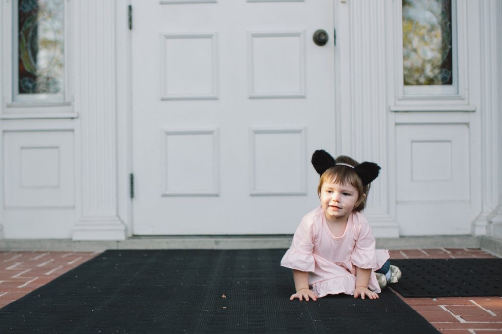 girl with wolf ears on porch of house for Muncie Family Photography
