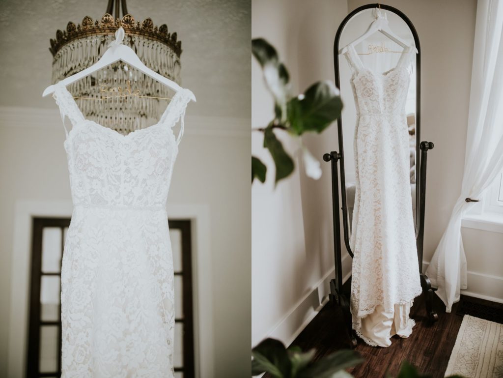 wedding dress hanging from a chandelier and a mirror at mustard seed gardens