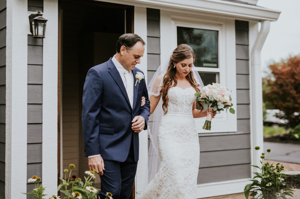 father of bride walks bride out of house at mustard seed gardens on wedding day