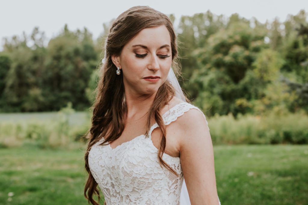 bride looks down at her flowers for this Noblesville Wedding Photography