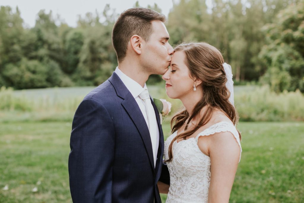groom kisses bride on forehead during Noblesville Wedding Photography